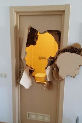 The bathroom door smashed by U.S. Bobsled team member Johnny Quinn when he became trapped inside.