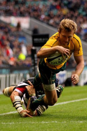 Lachie Turner of the Wallabies evades the tackle from Victor Matfield of the Barbarians to score on the stroke of halftime.