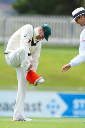Running repairs: Michael Clarke removes a compression bandage.