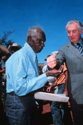 Gough Whitlam pours sand into the hand of Vincent Lingiari in 1975.