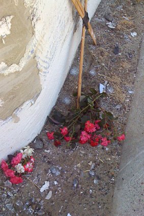 A small cross adorned with flowers has been established on the roadside where a young mother was fatally run down. <i>Photo: Aja Styles.</i>