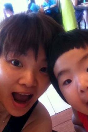 A mother's pride and joy: Missing passenger Gu Naijun with one of her children.