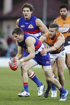 Western Bulldogs player Jason Tutt gets tackled on Saturday.