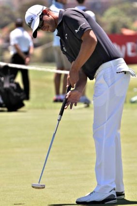 New broom: Adam Scott practises with a shorter putter at The Lakes for this week's Australian Open.
