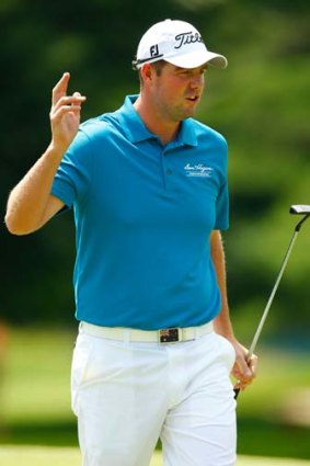 Marc Leishman acknowledges the crowd after sinking a putt during the first round of the 2013 Travellers Championship.
