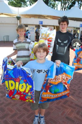 Dean Millen-Macdonald, his brother Riley, and Andre Christian display their show bags.