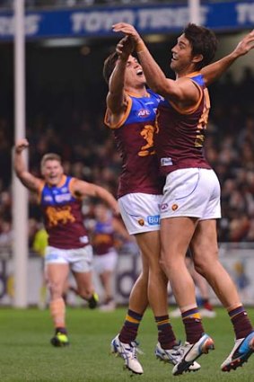 Lions dance: Brent Staker (right) celebrates with Jed Adcock after Staker's late goal sealed Brisbane's win.