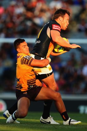 No holding back: Gavin Cooper of the Cowboys drives the ball forward against the Broncos.