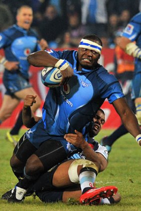 El Toro ... Bulls forward Chiliboy Ralepelle is brought down by Kurtley Beale at Loftus Versfeld.