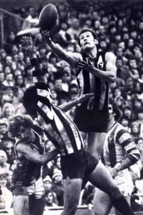 Flying high: Phil Carman soars above the rest to take a mark against North Melbourne in 1977.