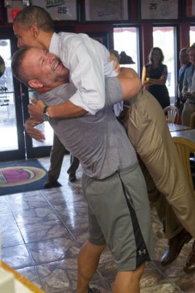 US President Barack Obama is picked up by pizza owner Scott Van Duzer during a visit to his restaurant in Fort Pierce, Florida.