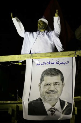 Rival campaigns ... a cleric addresses Islamists supporting President Mohammed Mursi in Giza on Wednesday.