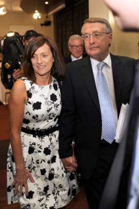 Team Swan: Leaving the National Press Club with his wife Kim in 2012.