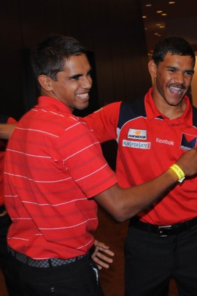 Lewis Jetta  who was drafted by Swans, is congratulated by first cousin Neville (from Melbourne).