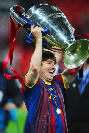 The Messi-ah ... Barcelona maestro Lionel Messi celebrates with the trophy after the UEFA Champions League final.