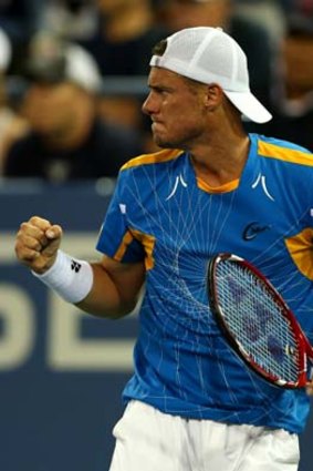 Lleyton Hewitt celebrates a point during his men's singles first-round match against Brian Baker of the US.