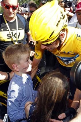 Bradley Wiggins greets his children after the final stage.