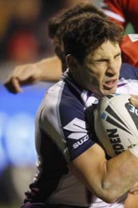 Going nowhere: Storm's Billy Slater is stopped in his tracks against the Dragons.