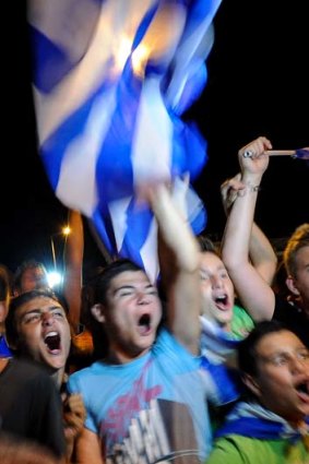 What currency crisis? ... Football fans in Athens savour Greece's victory over Russia in Euro 2012.