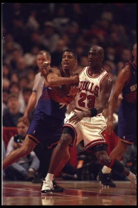 Kevin Johnson tangles with Michael Jordan in a Phoenix v Chicago clash in 1996.