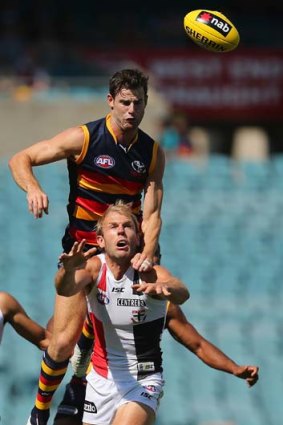 Andy Otten of the Crows and Beau Wilkes of the Saints compete for the ball.