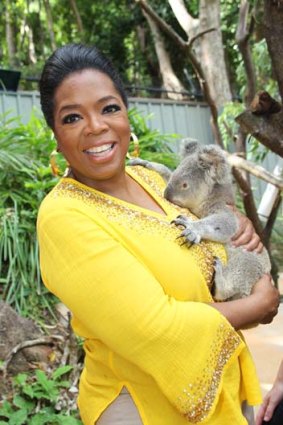 Oprah Winfrey meets a local koala at Hamilton Island Wildlife Park.