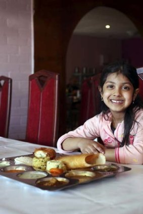 Good morning ... Maya Ghodra, 5, enjoys an Indian breakfast of dosai at Janani, Homebush.