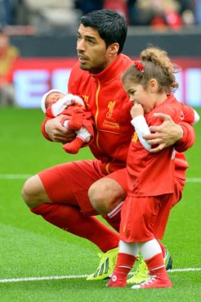 Hey dad: Luis Suarez at Anfield with his children.