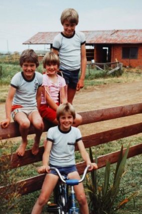 The Kaye's had a crop of handsome, sporty children - Jason, standing, John and Nicole, sitting on the fence, and Peter on his bike. 