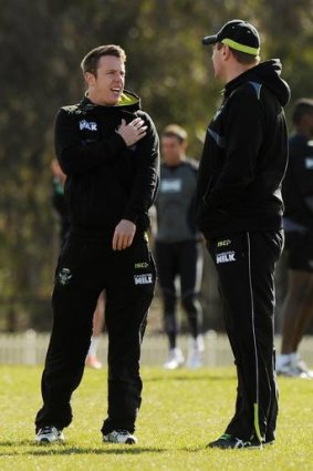 Raiders halfback Sam Williams points out his troubled shoulder to Canberra coach David Furner at training yesterday.