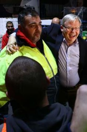 Say cheese: Kevin Rudd with employees at the Flemington Fruit Market.