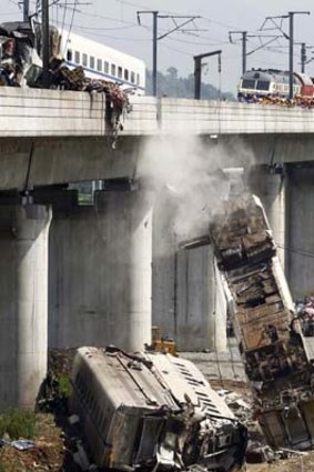 A derailed carriage of a bullet train is removed from the bridge.