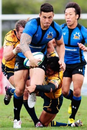 Eyes on the prize ... NTT Communications Shining Arcs players try to bring Sonny Bill Williams down.