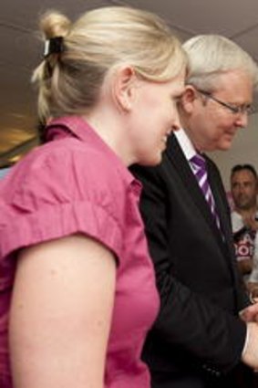 Kevin Rudd and Labor state member Kate Jones speak with locals in her Ashgrove electoral office today.