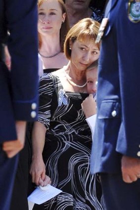Mourning ... Dave Rixon's wife Fiona and their youngest son at his funeral.