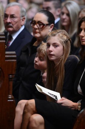 Sam Stynes mourns her husband during the service, with daughter Matisse and son Tiernan beside her.