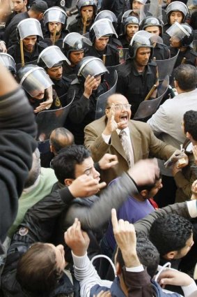 Riot police confront Egyptian demonstrators demanding an end to the 30-year rule of Hosni Mubarak in Cairo.