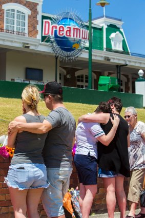 Locals grieve outside Dreamworld on Wednesday following Tuesday's fatalities.