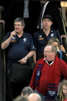 Carlton coach Brett Ratten, and football administration manager Shane O'Sullivan, arrive in Melbourne yesterday to a media pack, though at least one traveller couldn't have cared less.