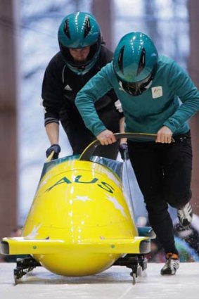 Astrid Radjenovic and Jana Pittman carry out a practice bobsleigh run.