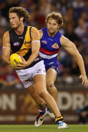 Tyrone Vickery of the Tigers gets away from Jake Stringer of the Bulldogs during the round three match on Saturday.