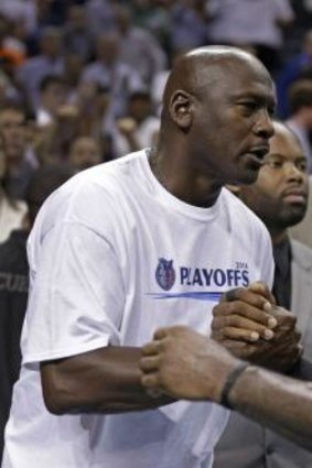 Charlotte Bobcats owner Michael Jordan, left, shakes hands with Miami Heat's LeBron James last week.