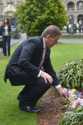 Premier Ted Baillieu lays flowers in the Memorial Garden at State Parliament.