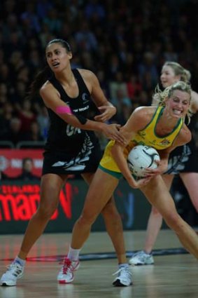 Mine: Australia's Laura Geitz holds onto the ball under pressure from Maria Tutaia.