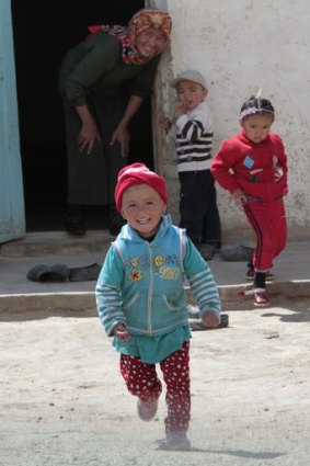 Children in the village of Alishur rush out to welcome visitors.