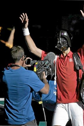 Novak Djokovic of Serbia arrives on court wearing a Darth Vader mask.
