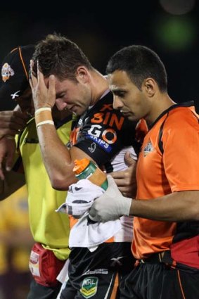 Heartbreaker: Tim Moltzen leaves the pitch after suffering another serious knee injury.
