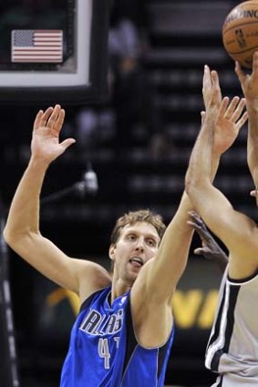 Dirk Nowitzki of the Dallas Mavericks defends against San Antonio Spurs' Tony Parker.