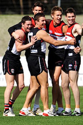 Steven Baker (second from left) celebrates his selection with teammates yesterday.