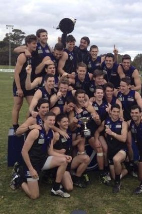Uni Blacks celebrate their first Premier division flag in 40 years.